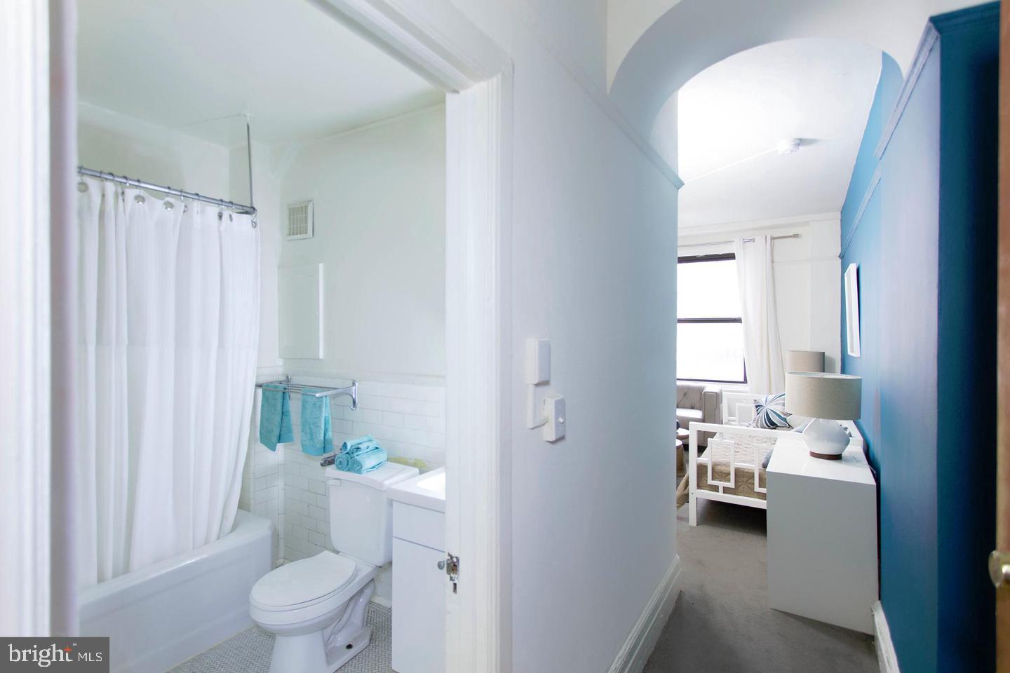 1229 Chestnut Street, Unit 1124 Philadelphia, PA 19107 - Photo 19 of 21 a bathroom with a sink a toilet and shower curtain