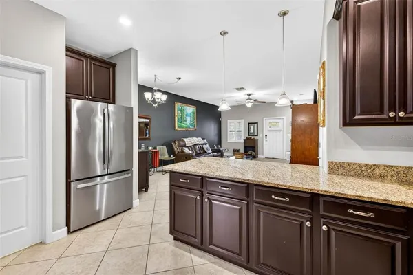 a kitchen with stainless steel appliances granite countertop a refrigerator a sink and a refrigerator