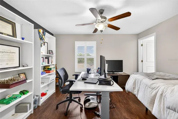 a living room with furniture and a bookshelf