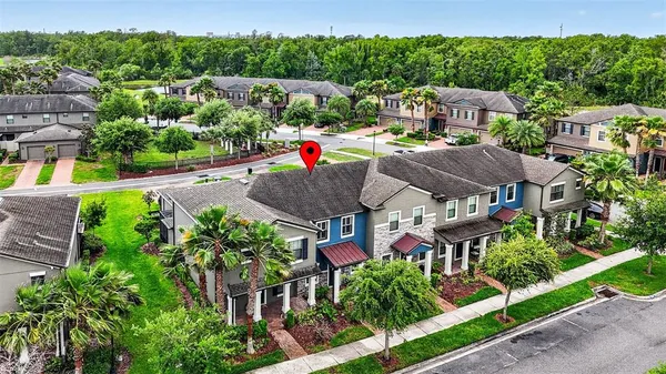 an aerial view of a house with a garden and lake view
