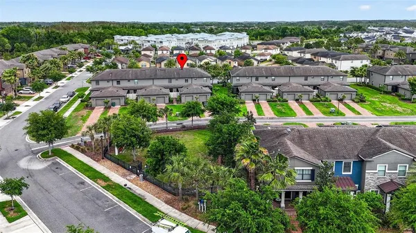 an aerial view of a house with a garden and lake view