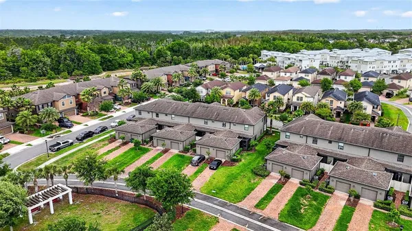 an aerial view of multiple houses with yard