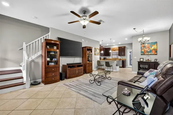 a work room with furniture a air conditioner and a window