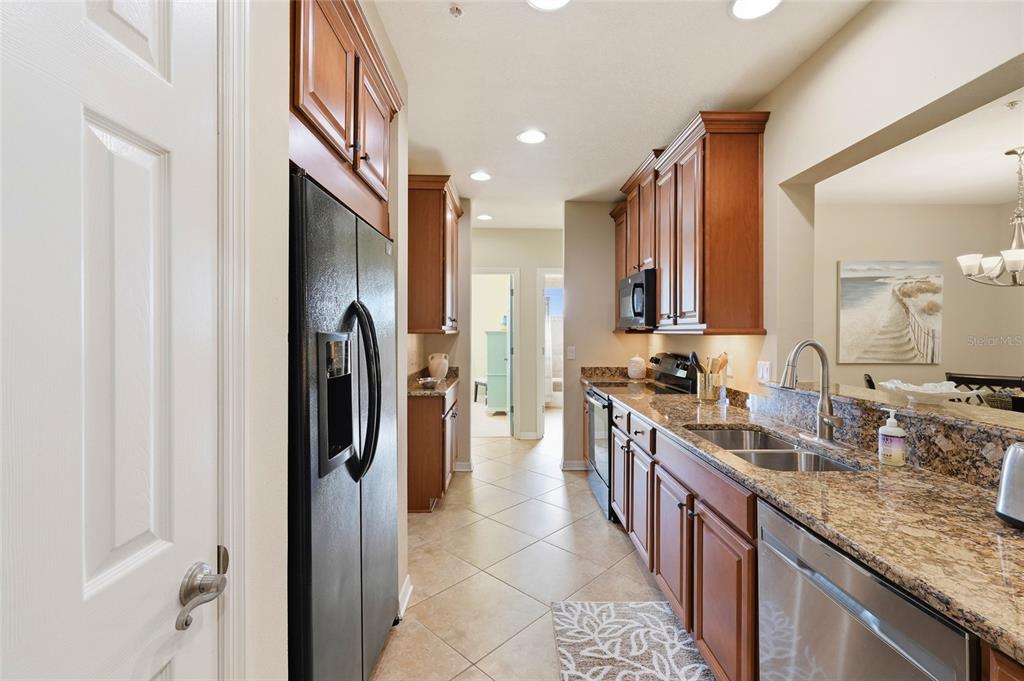 7321 Skybird Road, Unit 397 Bradenton, FL 34209 - Photo 11 of 35 a large kitchen with stainless steel appliances granite countertop a refrigerator and a sink