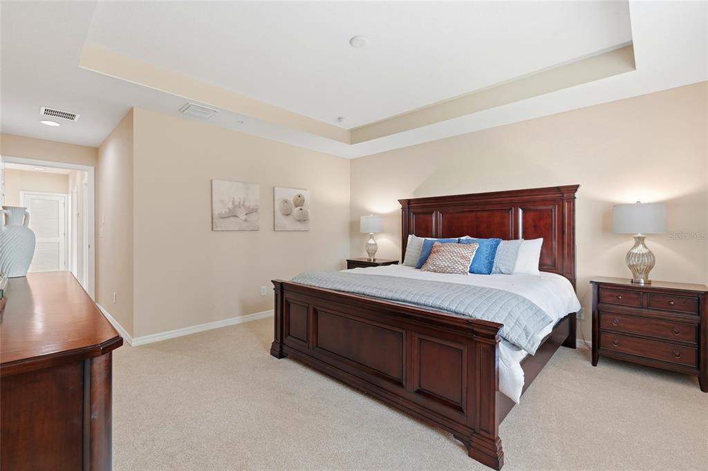 7321 Skybird Road, Unit 397 Bradenton, FL 34209 - Photo 13 of 35 a bedroom with a bed and a lamp with window