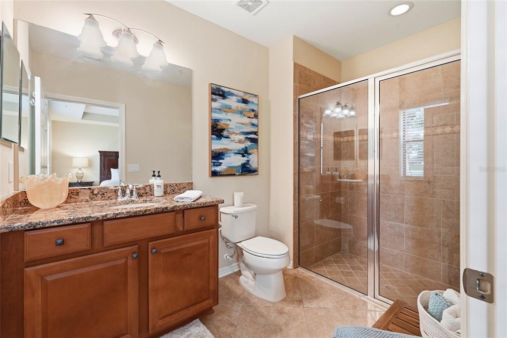 7321 Skybird Road, Unit 397 Bradenton, FL 34209 - Photo 14 of 35 a spacious bathroom with a granite countertop sink toilet and shower