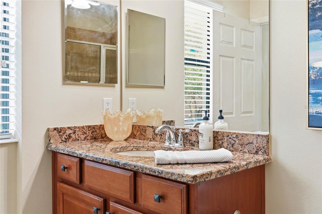 7321 Skybird Road, Unit 397 Bradenton, FL 34209 - Photo 15 of 35 a bathroom with a granite countertop sink and a mirror