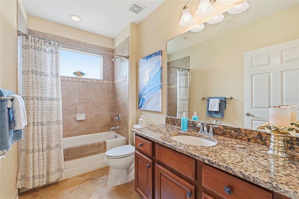 7321 Skybird Road, Unit 397 Bradenton, FL 34209 - Photo 21 of 35 a bathroom with a granite countertop sink toilet and shower