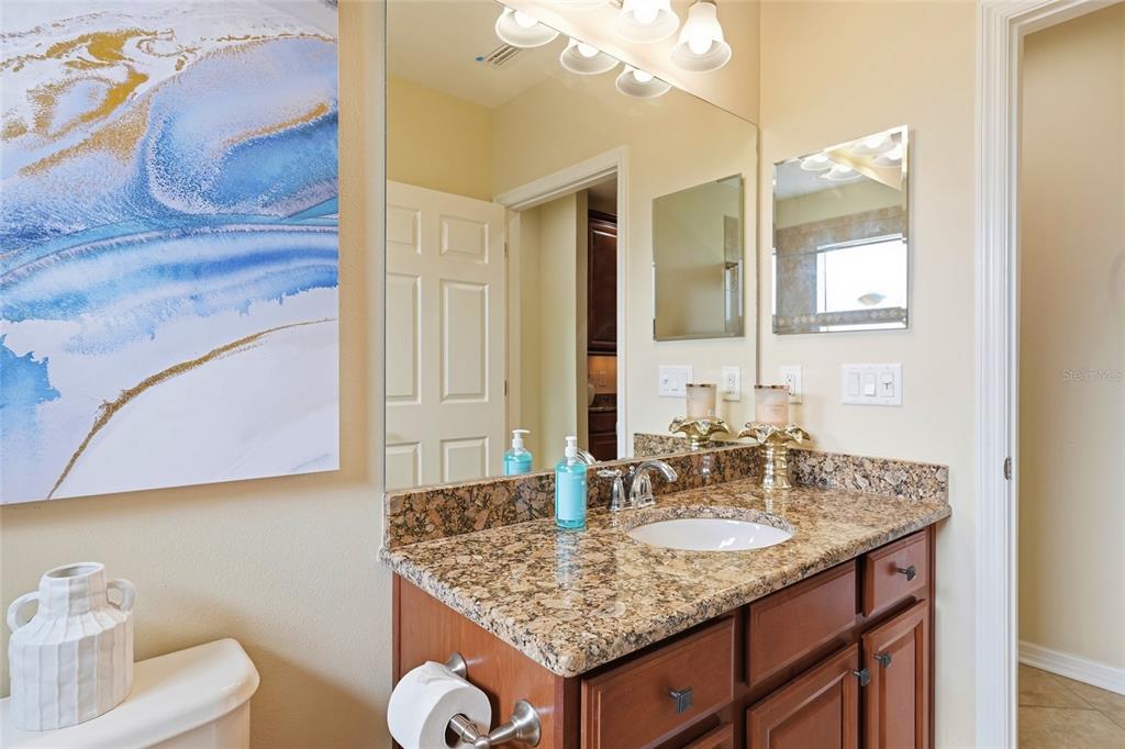7321 Skybird Road, Unit 397 Bradenton, FL 34209 - Photo 22 of 35 a bathroom with a granite countertop sink and a mirror