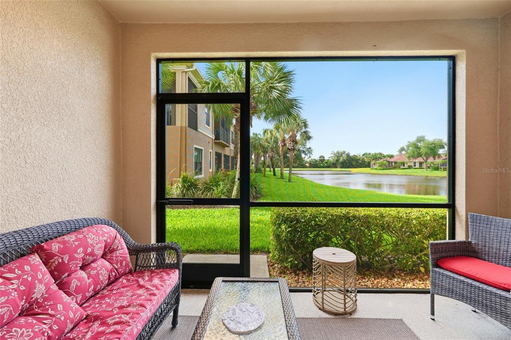 7321 Skybird Road, Unit 397 Bradenton, FL 34209 - Photo 28 of 35 a living room with furniture and a floor to ceiling window