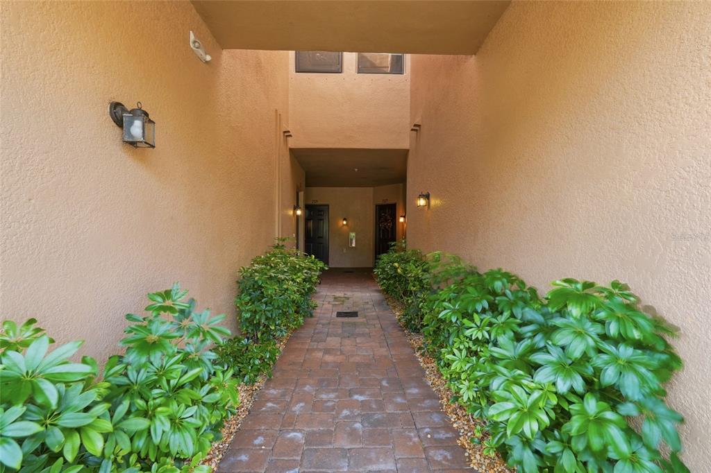 7321 Skybird Road, Unit 397 Bradenton, FL 34209 - Photo 3 of 35 a view of a pathway with flower pots