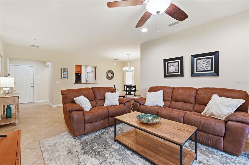 7321 Skybird Road, Unit 397 Bradenton, FL 34209 - Photo 5 of 35 a living room with furniture and a view of kitchen