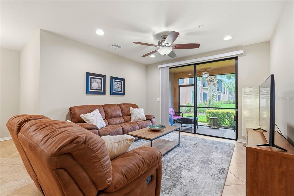 7321 Skybird Road, Unit 397 Bradenton, FL 34209 - Photo 7 of 35 a living room with furniture ceiling fan and a window