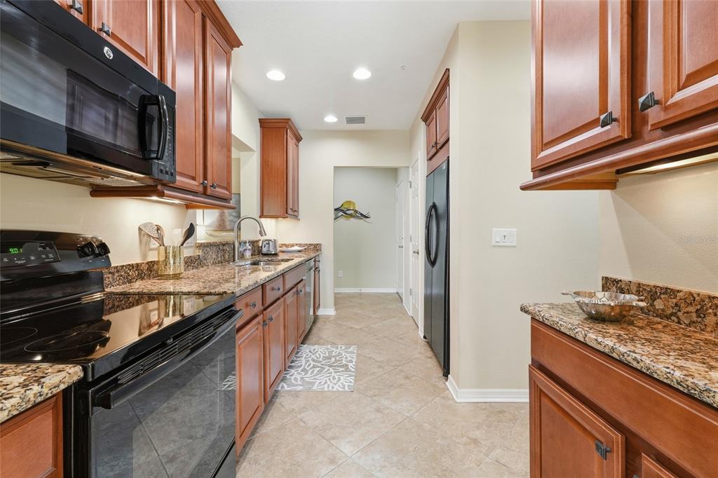 7321 Skybird Road, Unit 397 Bradenton, FL 34209 - Photo 8 of 35 a kitchen with stainless steel appliances granite countertop a stove and a sink