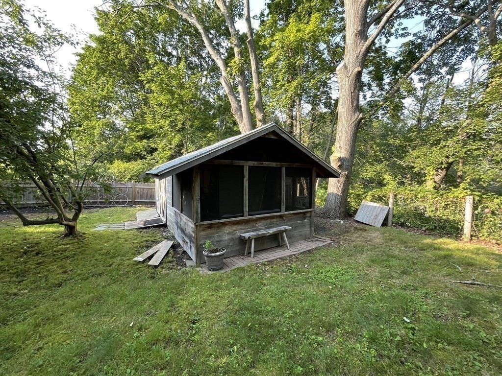 7 Temi Road Beverly, MA 01915 - Photo 35 of 40 a view of a backyard with table and chairs and a large tree