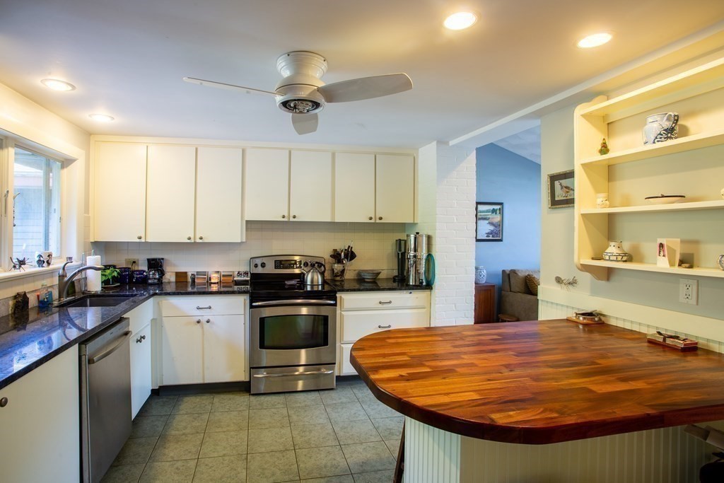 7 Temi Road Beverly, MA 01915 - Photo 9 of 40 a kitchen with stainless steel appliances granite countertop a sink a stove and cabinets