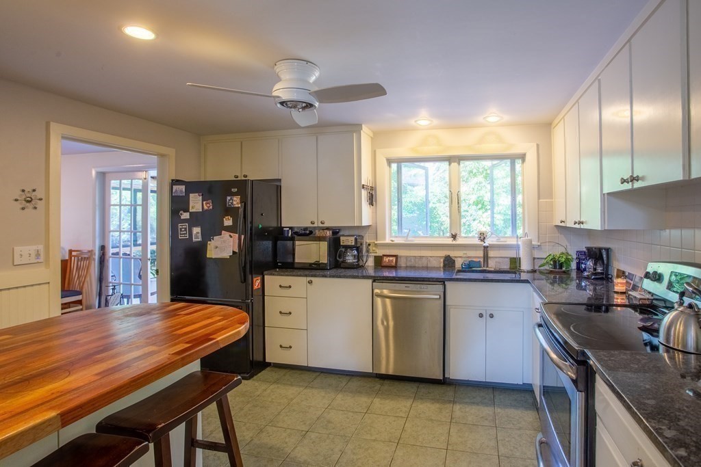 7 Temi Road Beverly, MA 01915 - Photo 10 of 40 a kitchen with stainless steel appliances granite countertop a sink a stove a refrigerator cabinets and dining table