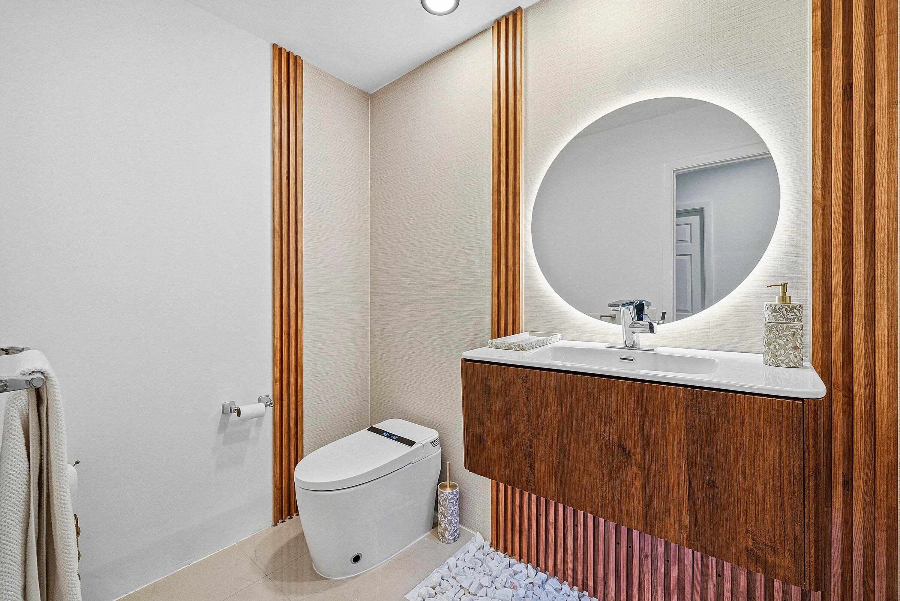 10710 Boca Woods Lane Boca Raton, FL 33428 - Photo 12 of 44 a bathroom with a toilet a sink and mirror