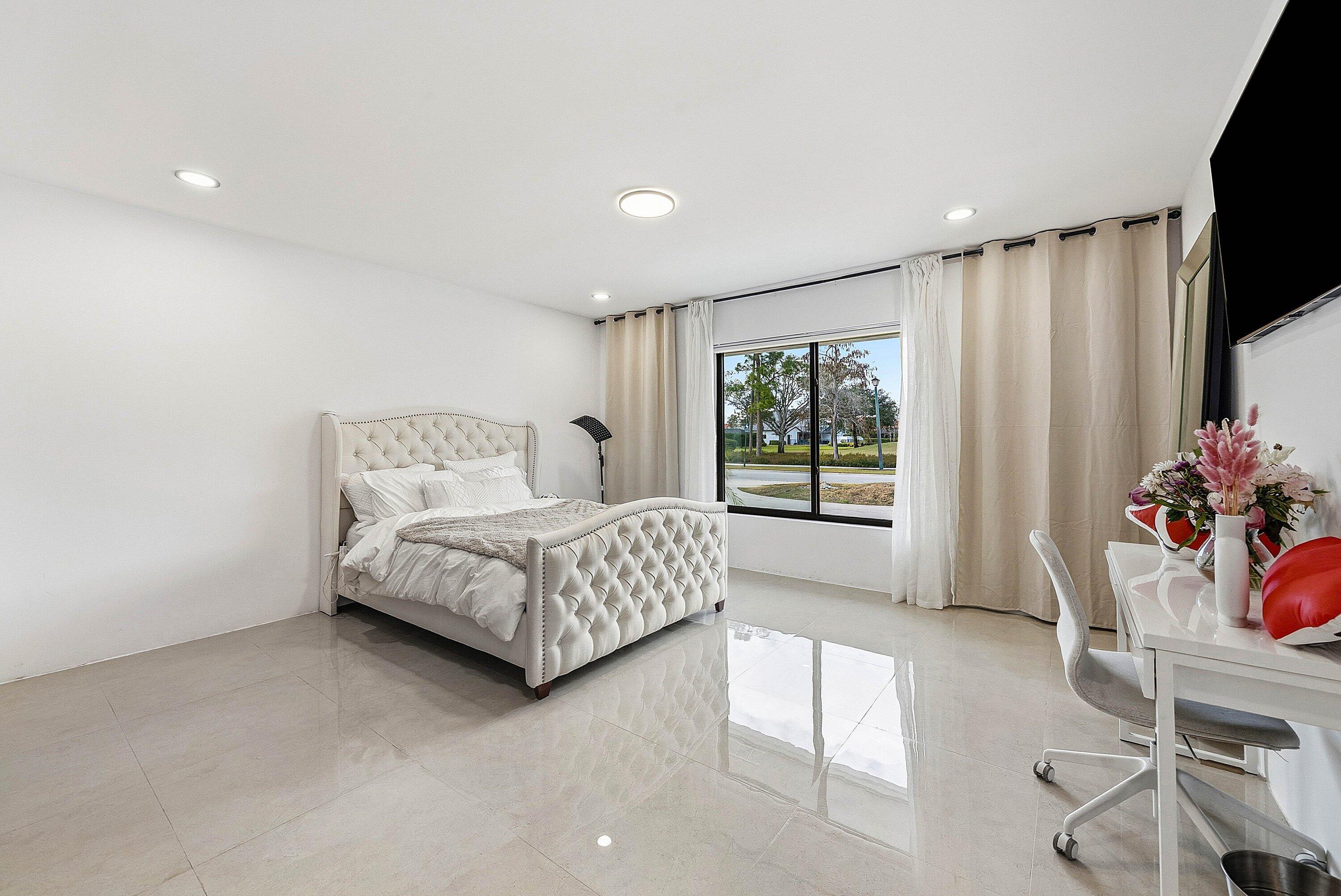 10710 Boca Woods Lane Boca Raton, FL 33428 - Photo 14 of 44 a bedroom with a bed and a window