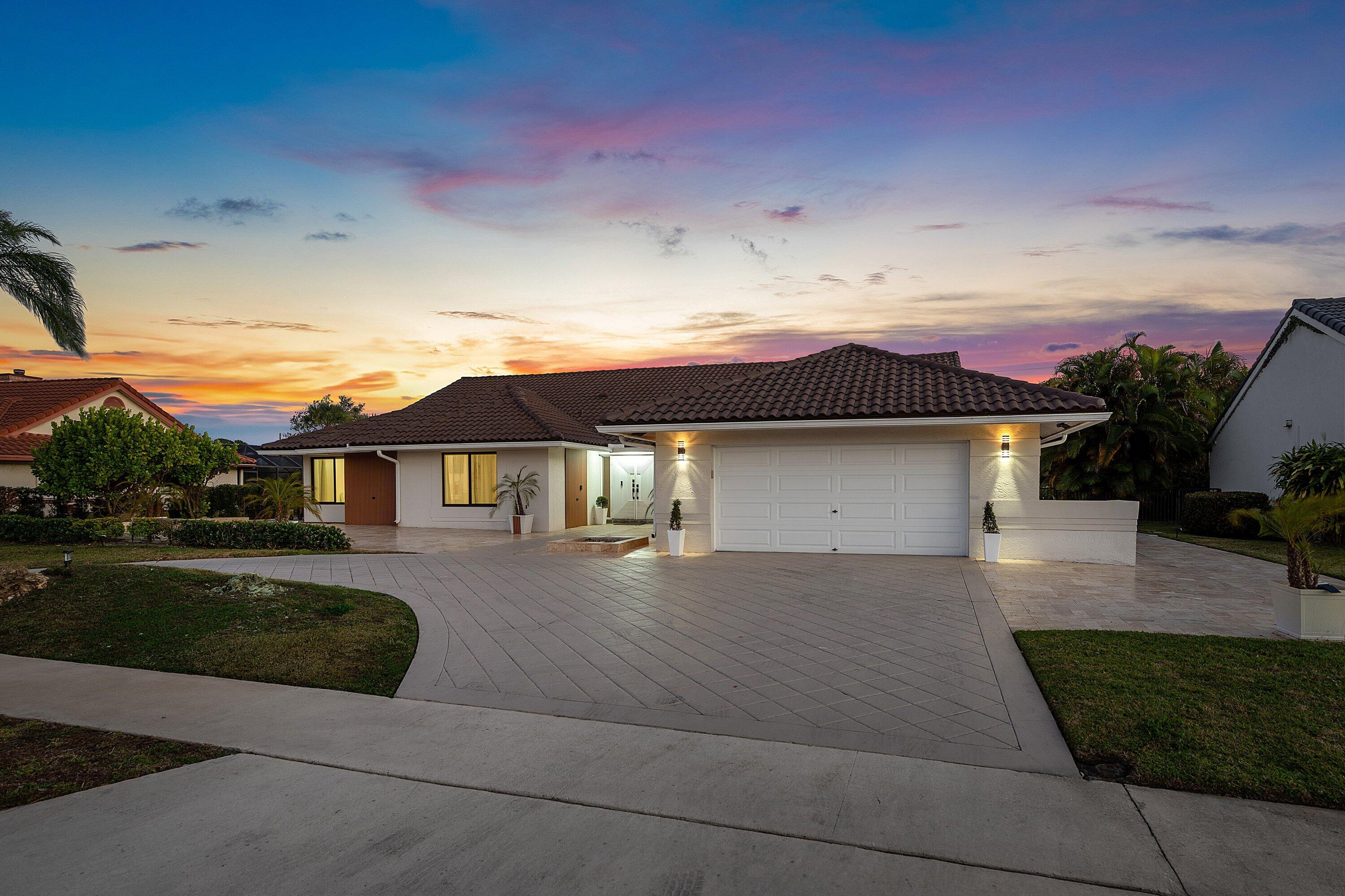 10710 Boca Woods Lane Boca Raton, FL 33428 - Photo 26 of 44 a front view of a house with a yard