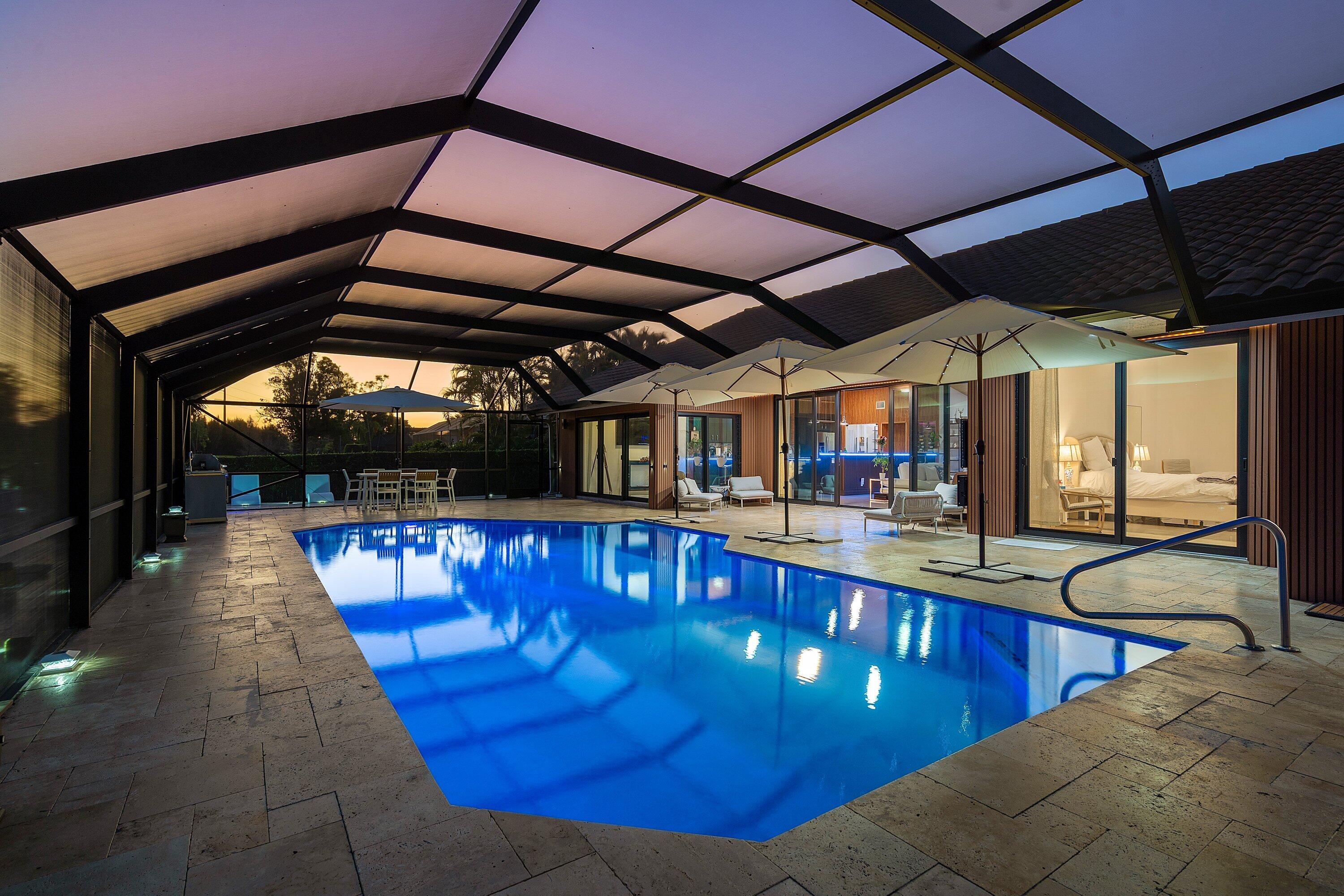 10710 Boca Woods Lane Boca Raton, FL 33428 - Photo 30 of 44 a view of a swimming pool with a patio