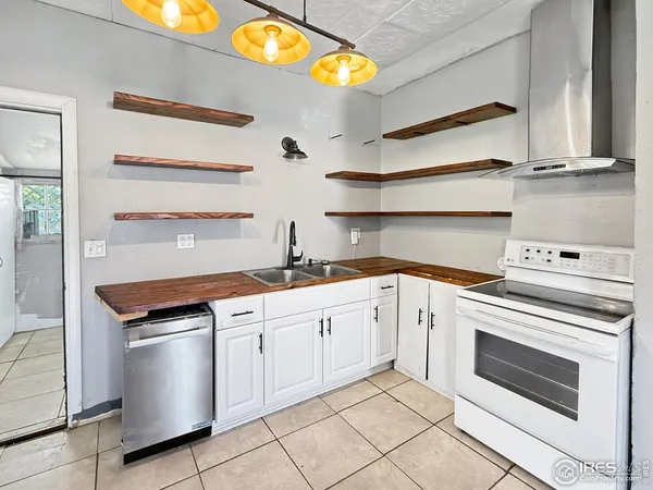a kitchen with stainless steel appliances a refrigerator and a stove