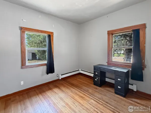 a view of a room with wooden floor cabinet and bathroom