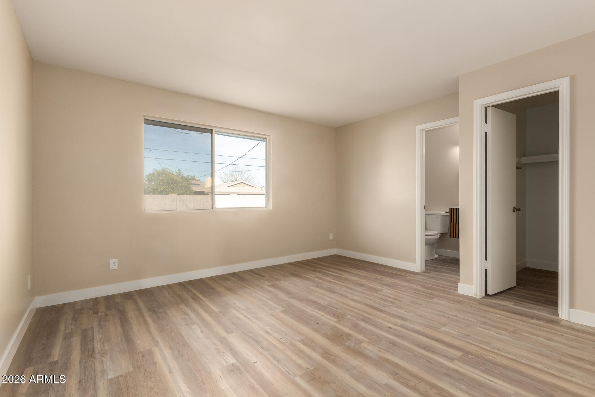 2834 East Shangri-La Road Phoenix, AZ 85028 - Photo 16 of 33 a view of an empty room with wooden floor and a window