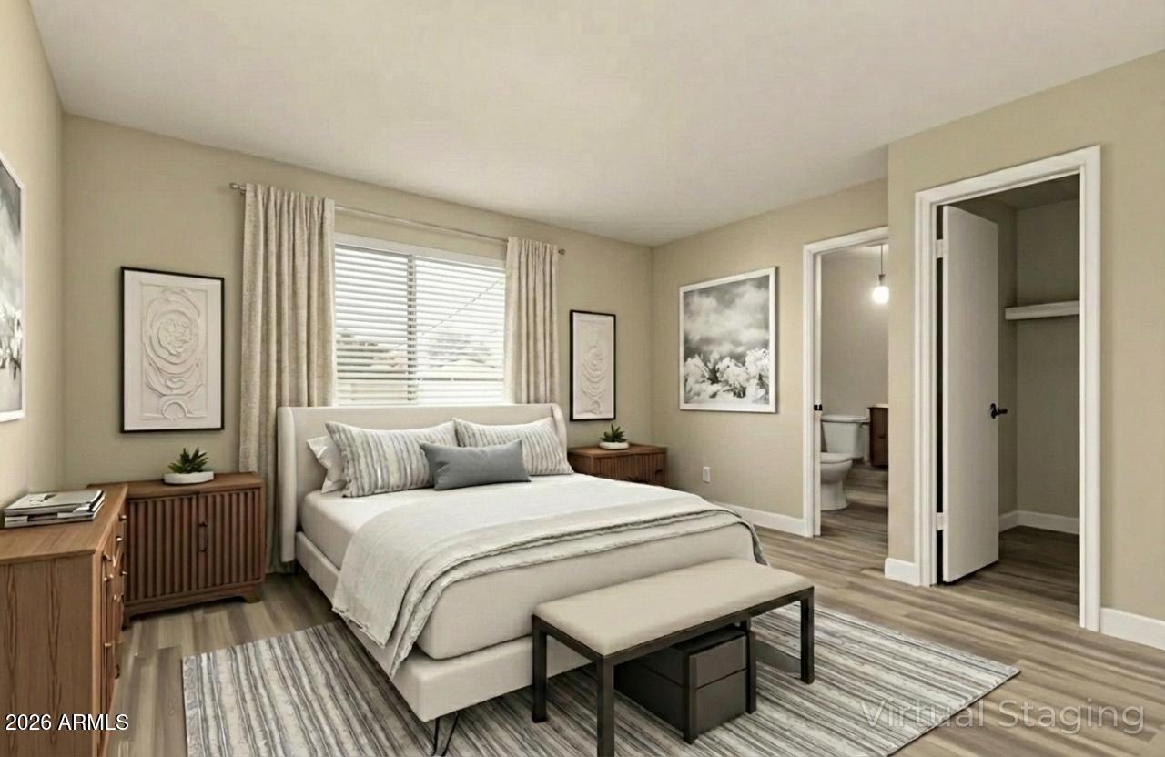 2834 East Shangri-La Road Phoenix, AZ 85028 - Photo 17 of 33 a bedroom with a bed and wooden floor