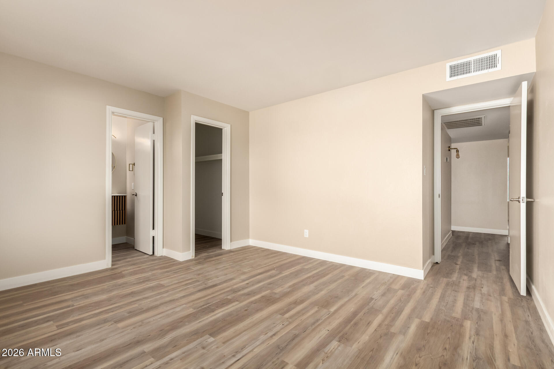 2834 East Shangri-La Road Phoenix, AZ 85028 - Photo 18 of 33 an empty room with wooden floor and closet