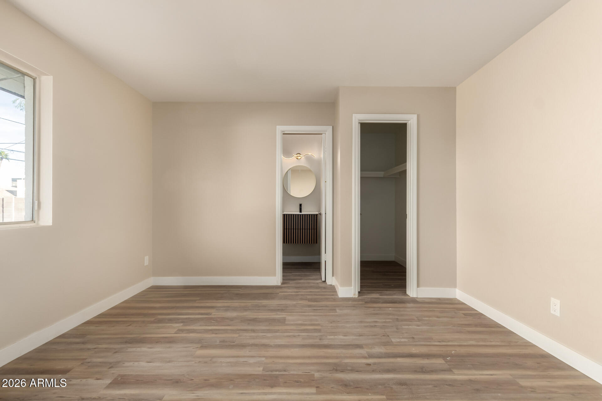 2834 East Shangri-La Road Phoenix, AZ 85028 - Photo 19 of 33 a view of an empty room with wooden floor and window
