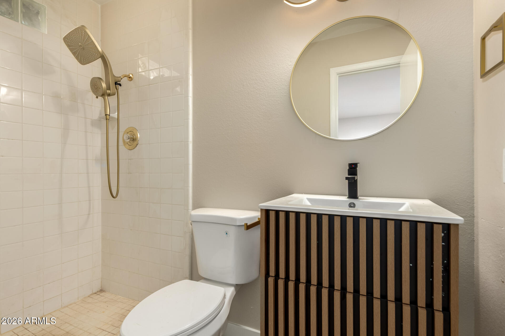 2834 East Shangri-La Road Phoenix, AZ 85028 - Photo 20 of 33 a bathroom with a toilet a sink and mirror