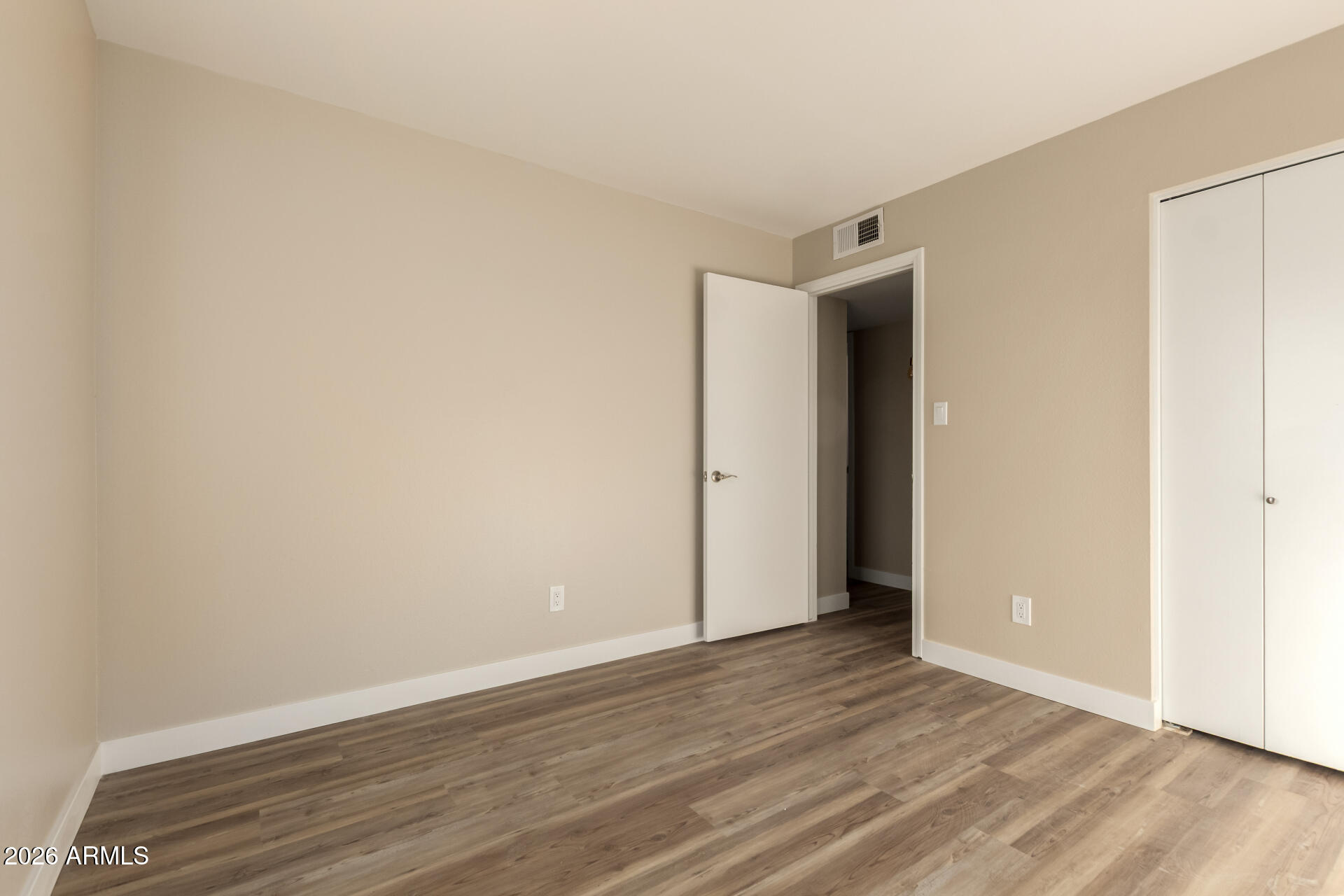 2834 East Shangri-La Road Phoenix, AZ 85028 - Photo 23 of 33 a view of an empty room with wooden floor and closet