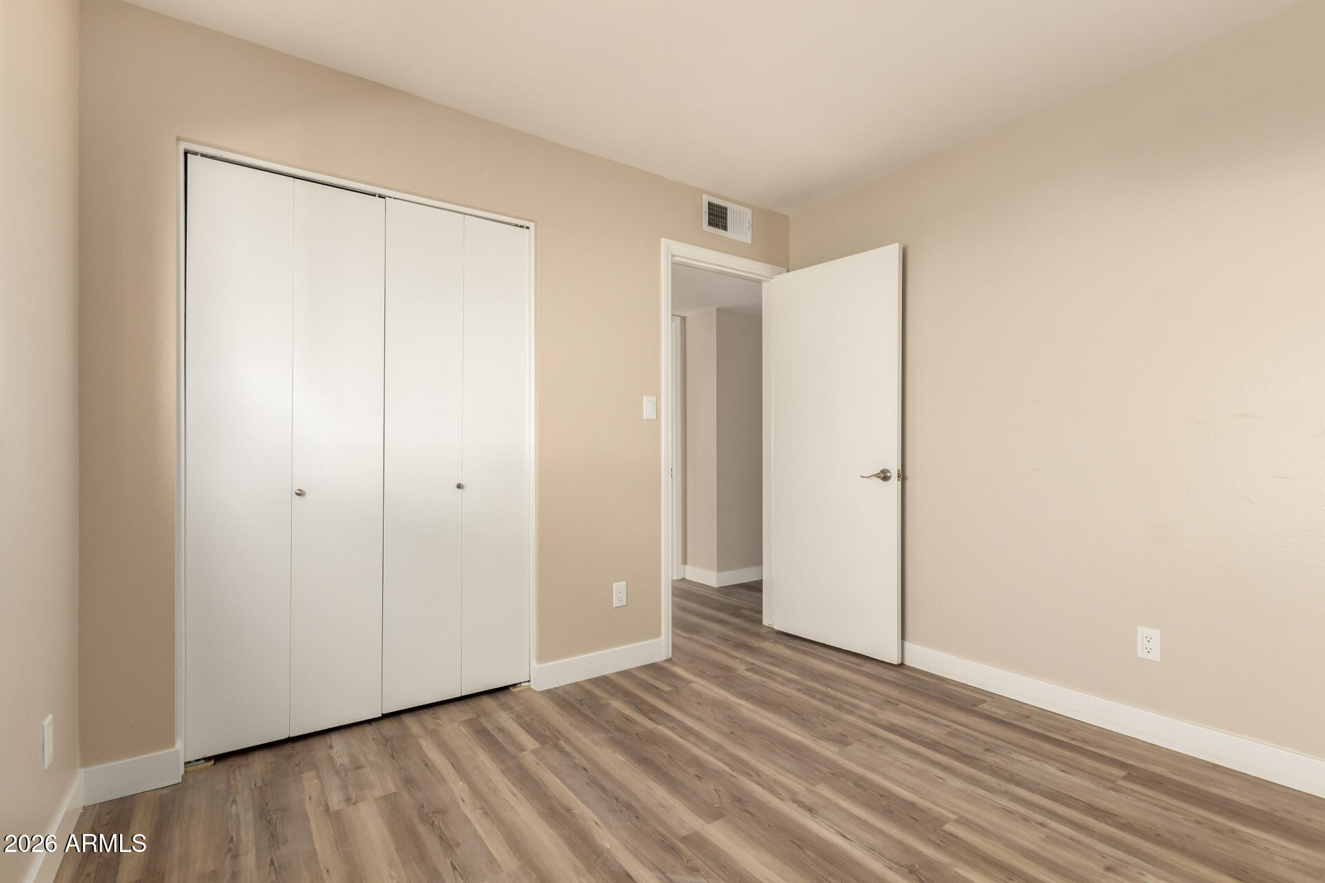2834 East Shangri-La Road Phoenix, AZ 85028 - Photo 26 of 33 a view of an empty room with wooden floor