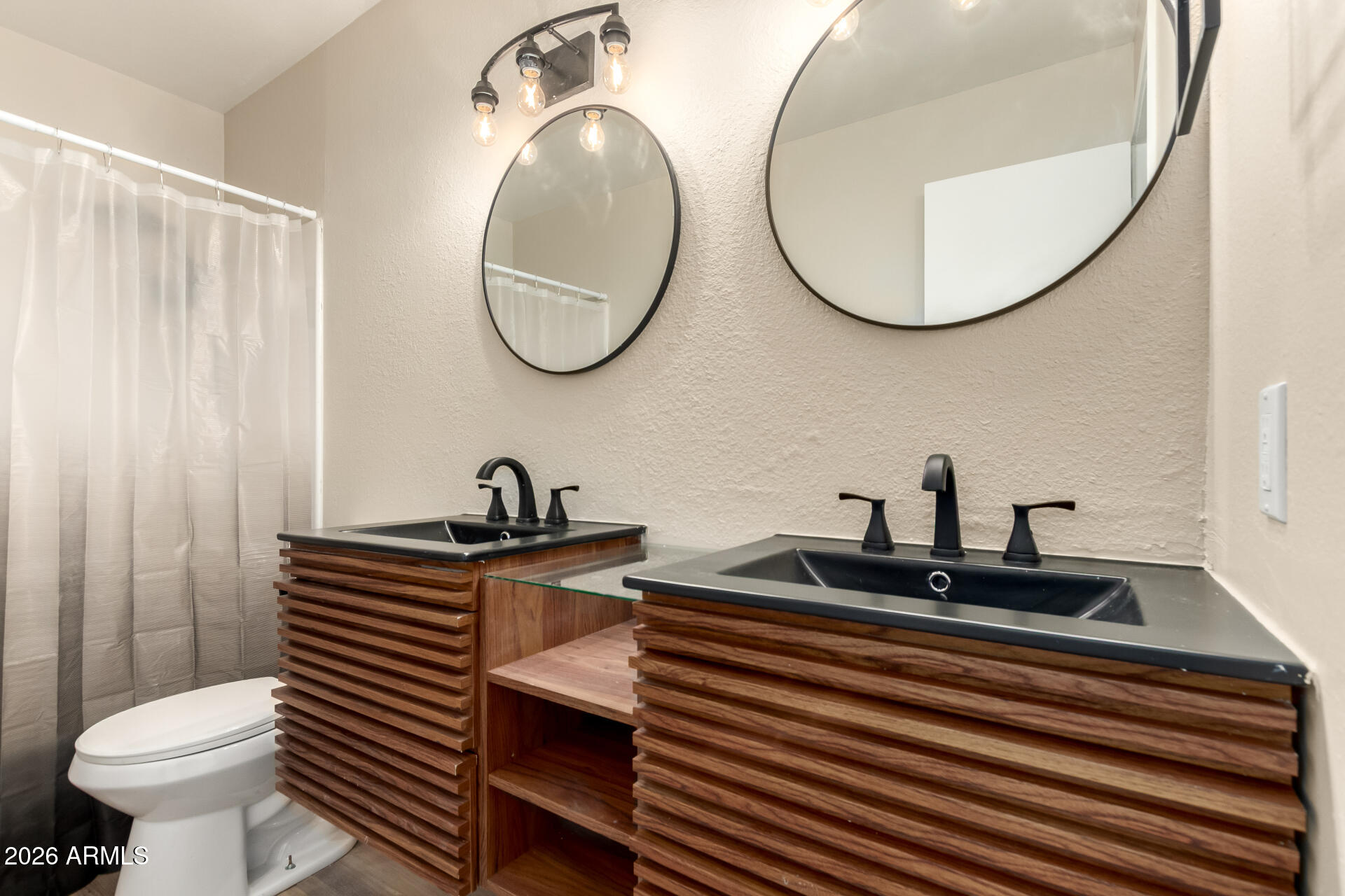 2834 East Shangri-La Road Phoenix, AZ 85028 - Photo 27 of 33 a bathroom with a sink a mirror and a toilet