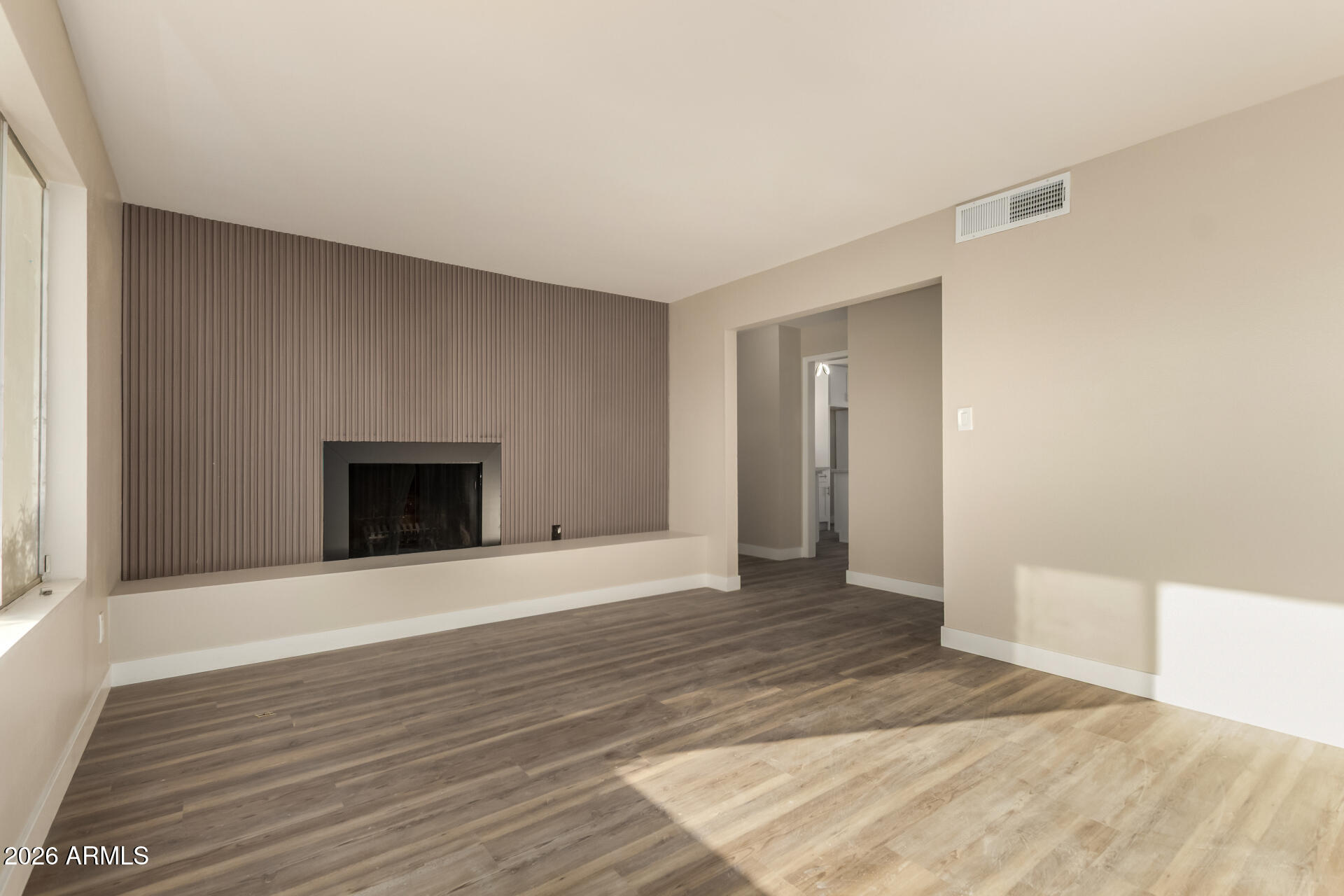 2834 East Shangri-La Road Phoenix, AZ 85028 - Photo 6 of 33 a view of an empty room with wooden floor and a window