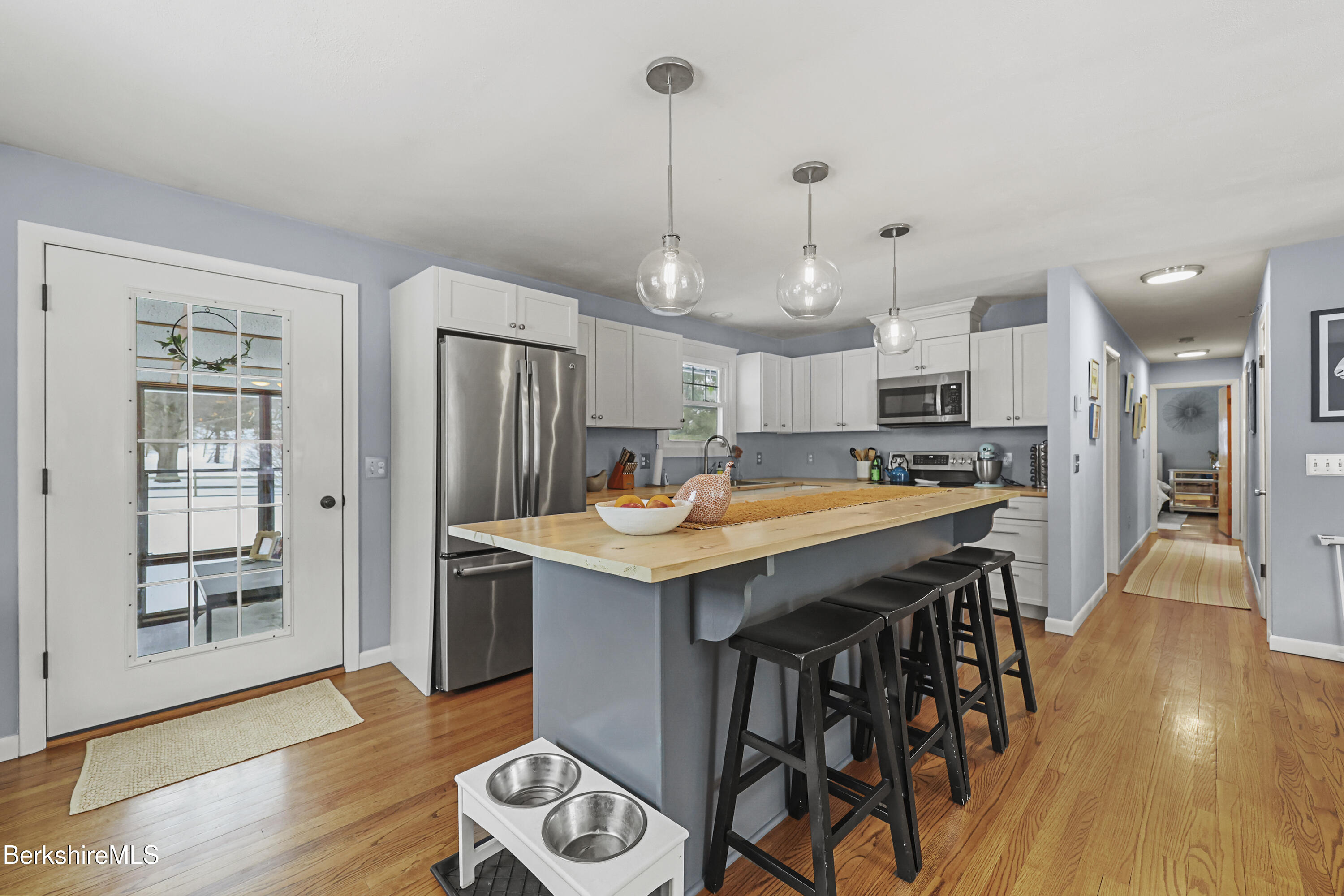 184 Washington Mountain Road Lee, MA 01238 - Photo 12 of 42 a kitchen with stainless steel appliances kitchen island hardwood floor and wooden floors