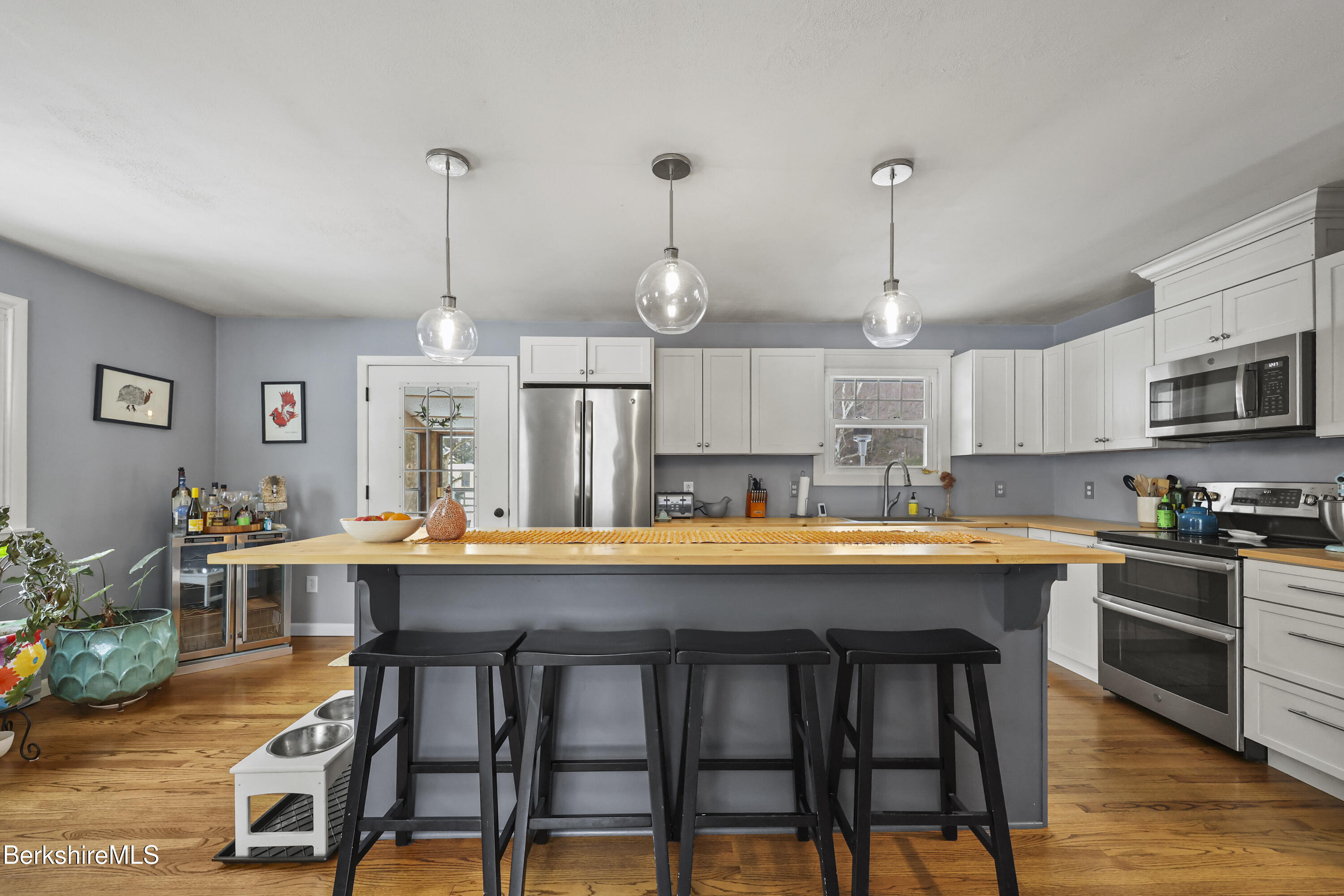184 Washington Mountain Road Lee, MA 01238 - Photo 13 of 42 a kitchen with stainless steel appliances granite countertop a white cabinets and chairs