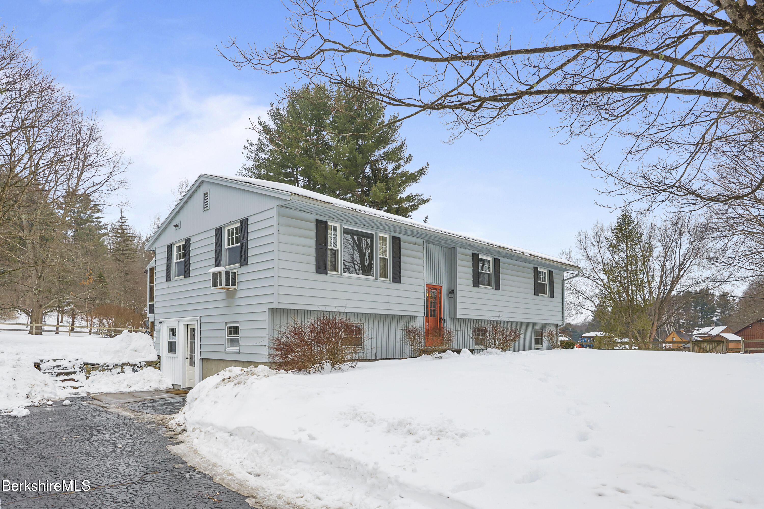 184 Washington Mountain Road Lee, MA 01238 - Photo 2 of 42 a front view of a house with a yard covered in snow