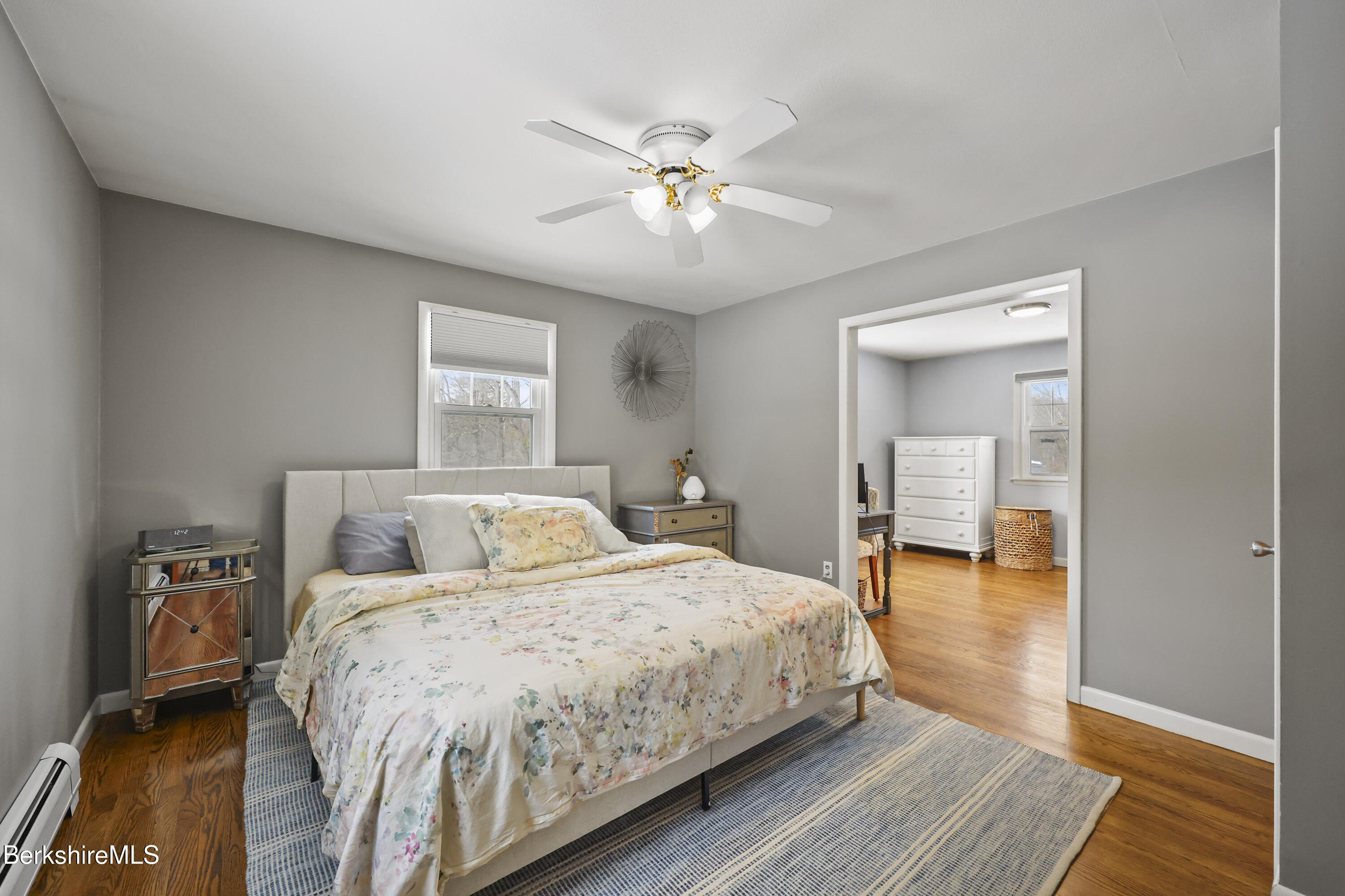 184 Washington Mountain Road Lee, MA 01238 - Photo 22 of 42 a bedroom with a large bed and a chandelier