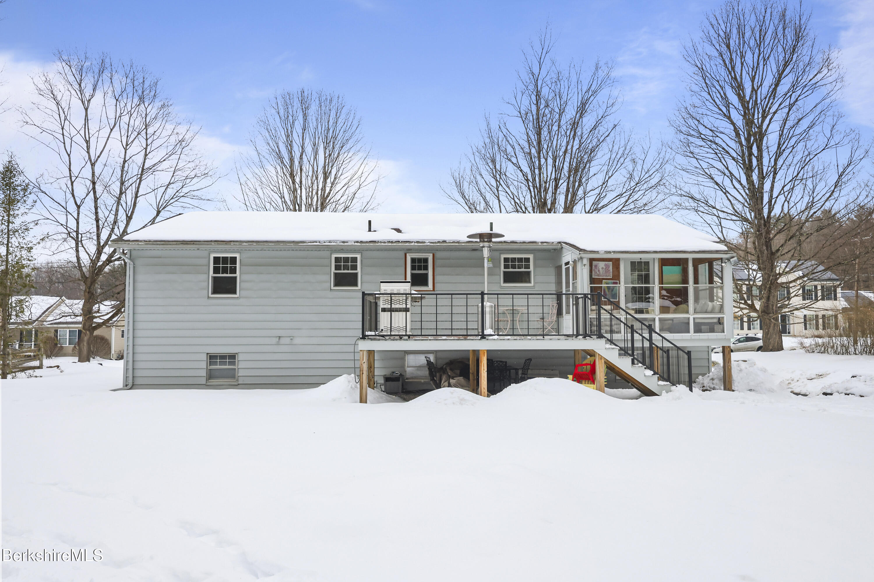 184 Washington Mountain Road Lee, MA 01238 - Photo 38 of 42 a view of a white house with a yard covered in snow
