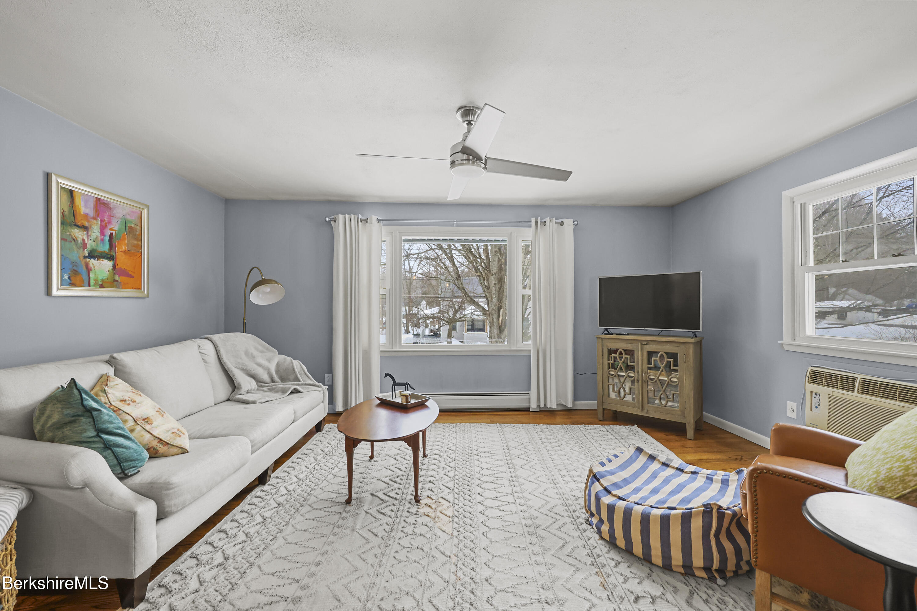 184 Washington Mountain Road Lee, MA 01238 - Photo 9 of 42 a living room with furniture a flat screen tv and a window