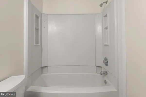 a white bath tub sitting next to a white toilet