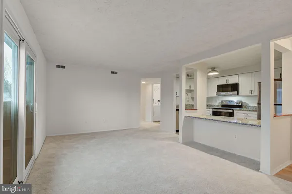a view of kitchen with stainless steel appliances refrigerator stove and microwave