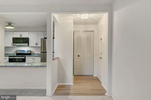 a view of a kitchen from the hallway