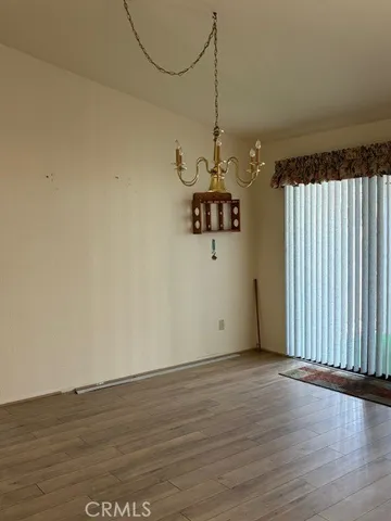 a view of a room with wooden floor air conditioner and a window