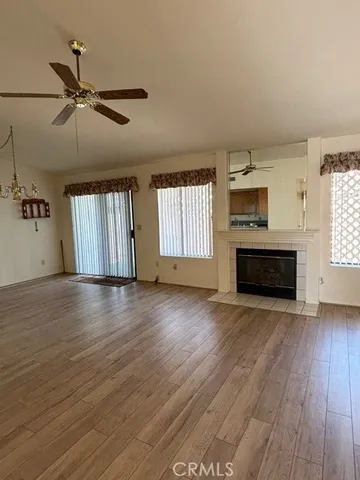 an empty room with windows fireplace and windows
