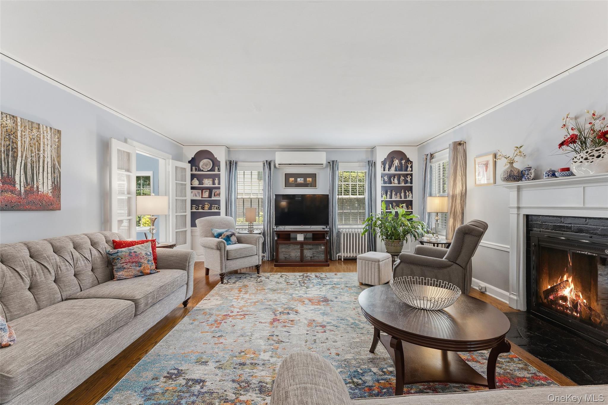 30 Birchbrook Road Bronxville, NY 10708 - Photo 3 of 34 Spacious Living Room with wood-burning fireplace and built-in shelves and cabinetry.