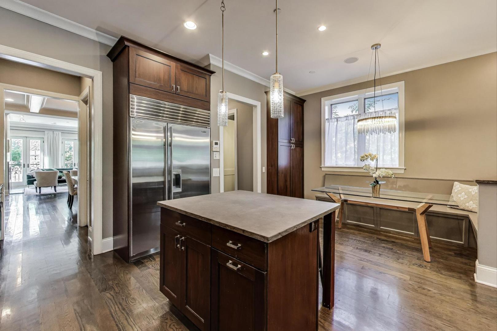 1758 West Surf Street Chicago, IL 60657 - Photo 11 of 51 a kitchen with center island wooden floor and a refrigerator