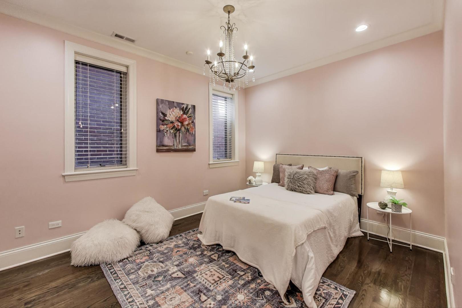 1758 West Surf Street Chicago, IL 60657 - Photo 28 of 51 a bedroom with a bed and wooden floor
